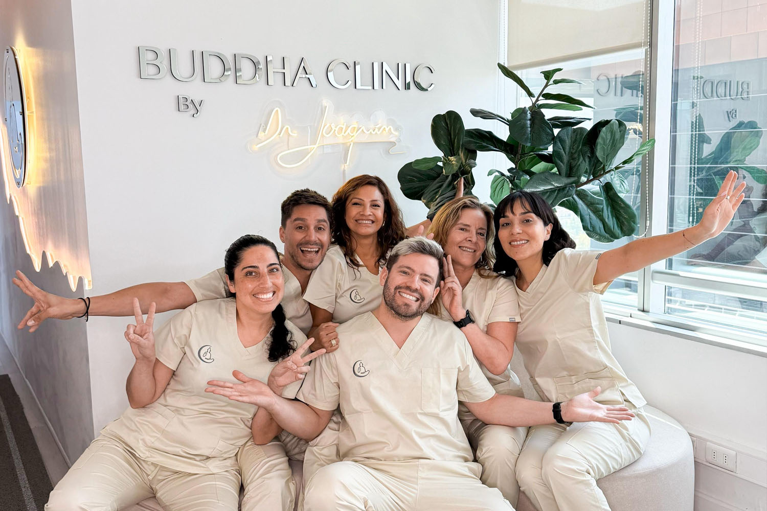 beautician touching beautiful woman face in blue gloves in cosme